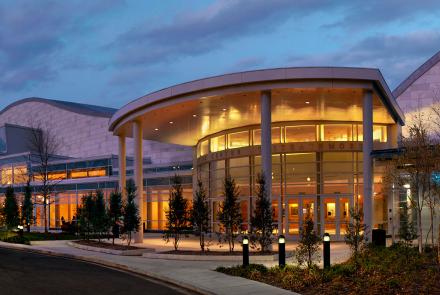 A photo of the exterior of the Strathmore arts center at night.