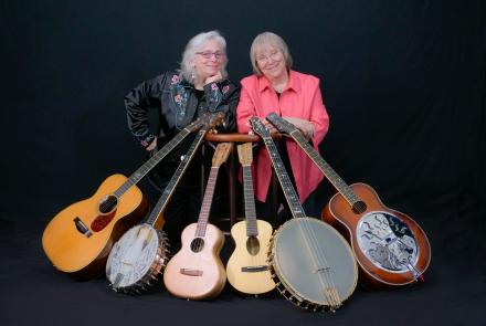 two women with banjos and guitars  