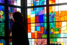 Henry Louis Gates in front of a stained glass window in "The Black Church"