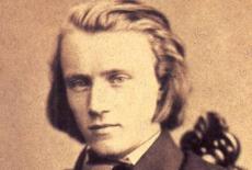 Sepia toned portrait picture of Johannes Brahms, young with no beard.
