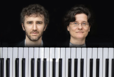 a creative picture with Sam and Ralitza heads above a piano keyboard. 