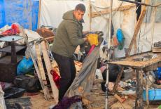 Palestinian man inspects the site of Wednesday's Israeli strike on tents, in Khan Younis