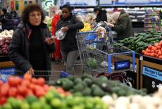 FILE PHOTO: Customers shop for groceries in Walmart Supercenter retail store in North Bergen, New Jersey