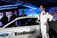 FILE PHOTO: Driver Biffle poses for photographs in front of the new 2013 Ford stock car after an announcement during the N...
