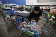 FILE PHOTO: Customers shop for groceries in Walmart Supercenter retail store in North Bergen, New Jersey