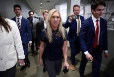 U.S. Representative Marjorie Taylor Greene (R-GA) walks to her final vote, surrounded by staff, in Washington