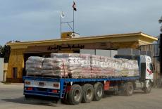 Trucks carrying humanitarian aid and fuel line up at the Rafah border to cross into the Gaza Strip, on the Egyptian side, ...