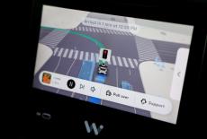 A self-driving Waymo car drives through Los Angeles