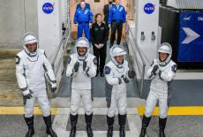 NASA's SpaceX Crew-12 crew members walk out of the Operations & Checkout Building at the Kennedy Space Center before t...