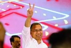 Tarique Rahman, chairman of Bangladesh Nationalist Party (BNP), shows victory sign during a press conference, following th...