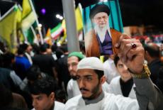 Supporters of Iraqi Shi'ite armed groups show support for Iran, in Basra
