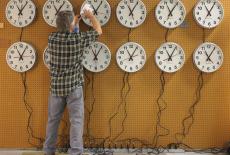Scott Gow cleans the faces of wall clocks being tested at the Electric Time Company in Medfield, Massachusetts