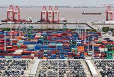 FILE PHOTO: Drone view shows electric vehicles (EV) for export and containers sitting at a port in Shanghai