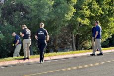 Police and FBI agents photograph and search woods near the Utah Valley University in Orem