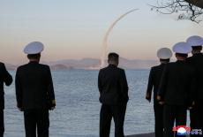 North Korean leader Kim Jong Un observes a test-fire of strategic cruise missiles and anti-warship missiles from the destr...