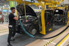 An employee of German car manufacturer Mercedes-Benz works on a Mercedes CLA class model, in Rastatt
