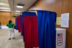 Signs inside an early voting location inform voters of a cancelled U.S. House race, in Baton Rouge