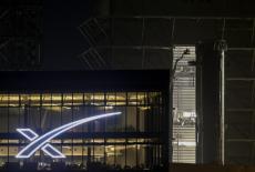SpaceX Super Heavy booster rolls past the production facility toward launch pad 2, in Starbase, Texas