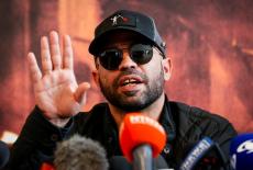 Former national chairman of the Proud Boys Enrique Tarrio talks to the media in Miami