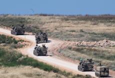 An Israeli military artillary unit drives into Lebanon after crossing the Israeli‑Lebanese border, as seen from northern I...