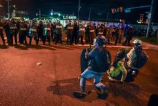 Protesters demonstrate in front of ICE officers outside Delaney Hall in Newark