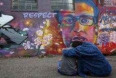People visit a mural ahead of the first anniversary of Elijah McClain's death