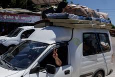 A family with their belongings loaded on top of their car, flees southern Lebanon following overnight fighting between Isr...