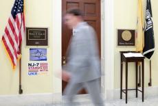 A man passes the office door of U.S. Rep. Kean on Capitol Hill in Washington