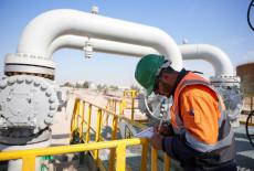 A worker checks equipment at the Rumaila oil field in Basra