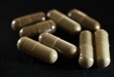 FILE PHOTO: In this photo illustration, capsules of the drug kratom are seen on May 10, 2016 in Miami. The herbal supplement is a psychoactive drug derived from the leaves of the kratom plant and it's been reported that people are using the supplement t...