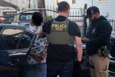 U.S. Immigration and Customs Enforcement (ICE) agents detain a man as part of a Targeted Enforcement Operation in the Coro...
