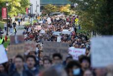 People attend a Justice for Survivors rally on at Cornell University in Ithaca, New York