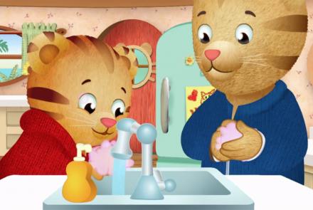 Daniel Tiger washing his hands with his parent.