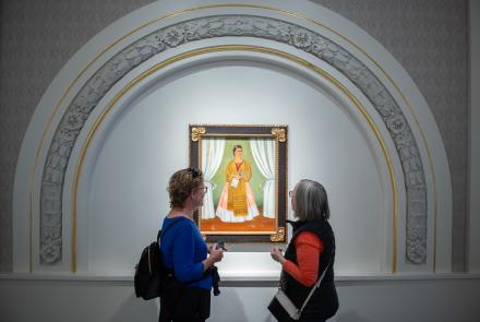 two women viewing a painting