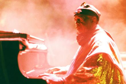 Sun Ra sitting at a piano