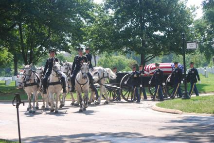 U.S. Army Caisson Platoon escorts a coffin at Arlington National Cemetery.