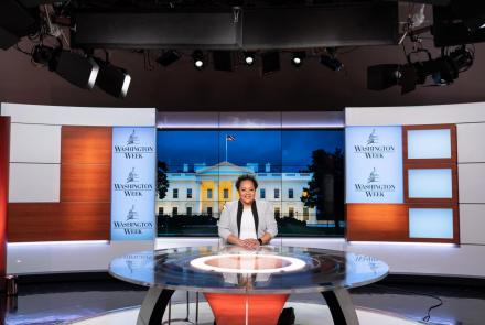 A wide shot of Yamiche Alcindor sitting at the table on the Washington Week set