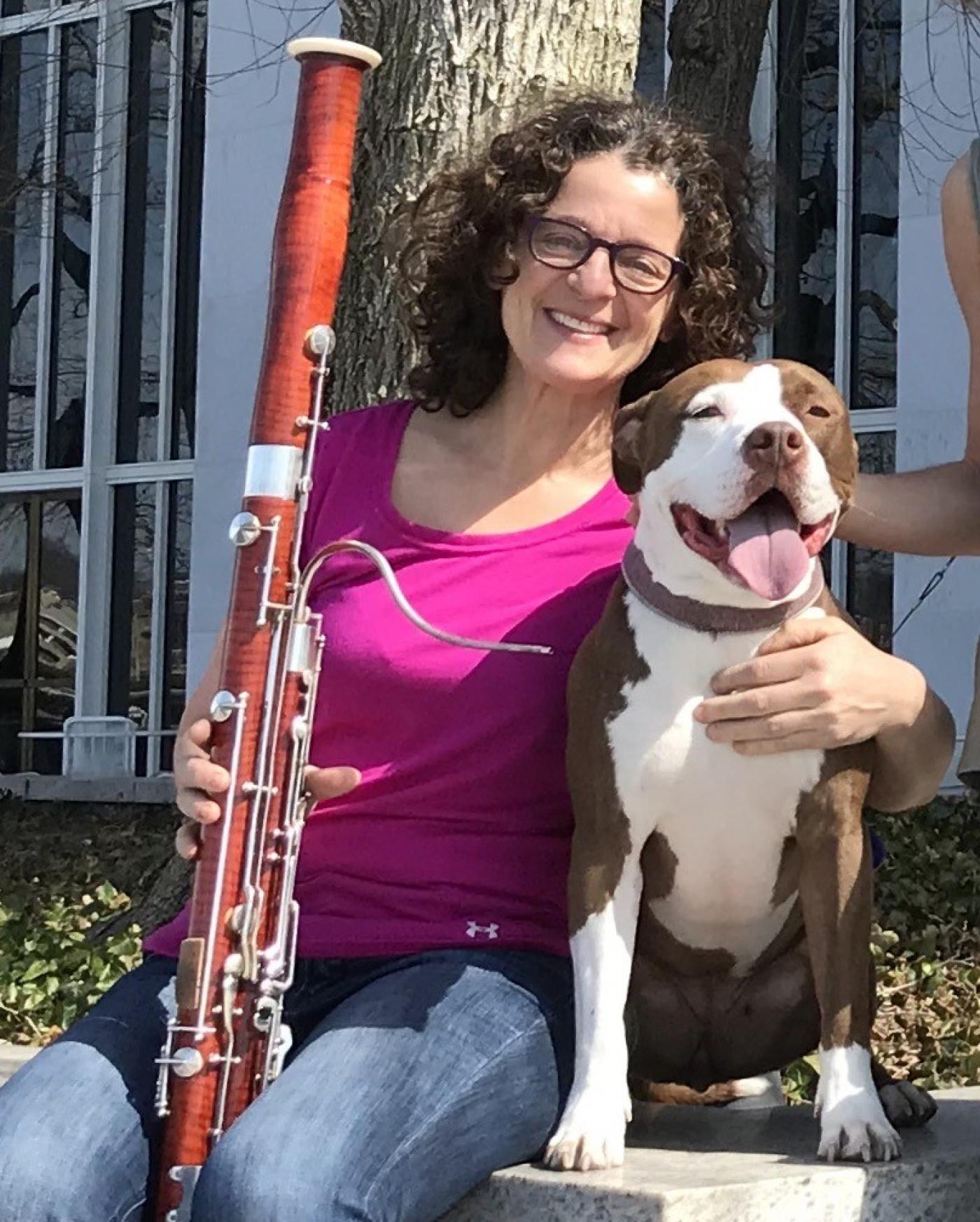 Sue Heineman with her bassoon and dog Bella