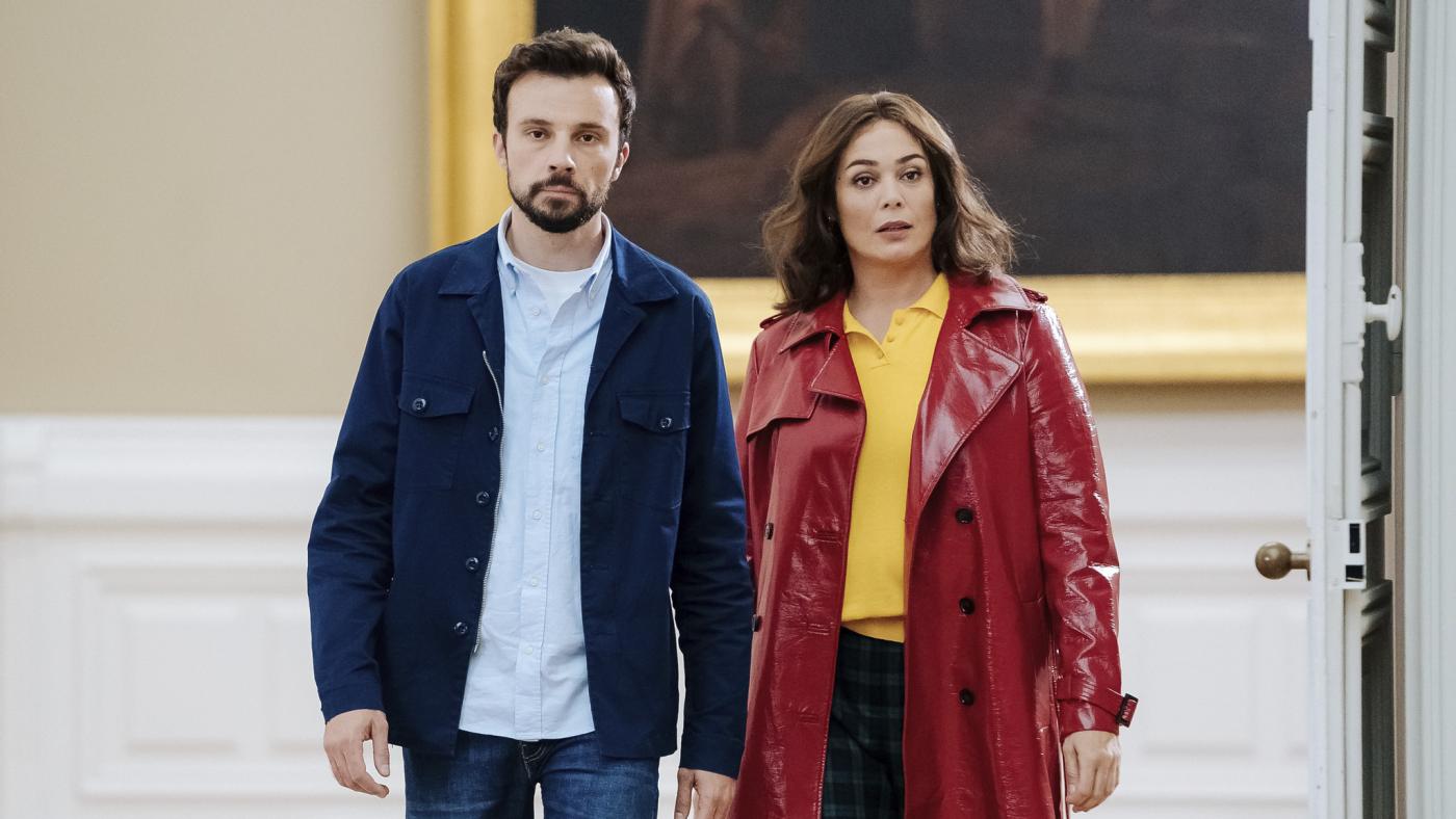 Mademoiselle Holmes in red jacket with yellow shirt with partner