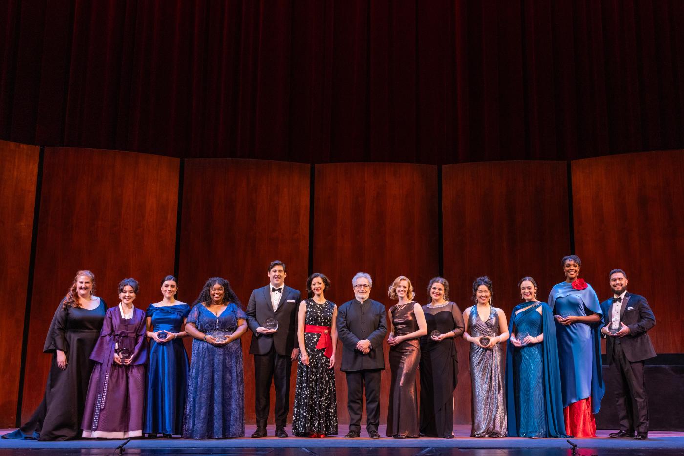 Soprano Lisette Oropesa and Maestro Carlo Rizzi (center ) with the 2026 Laffont Competition Finalists. Photo: Evan Zimmerman / Met Opera