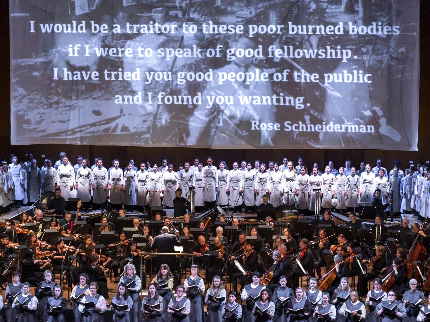 Wolfe incorporates theatrics and projections in her large-scale pieces for voices and orchestra, including this 2019 performance of <em>Fire in My Mouth</em> with the New York Philharmonic at David Geffen Hall.