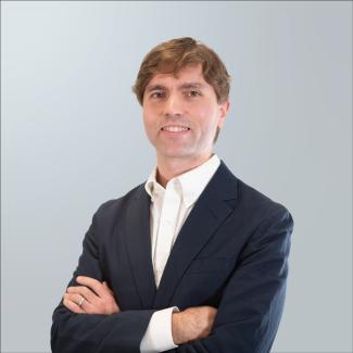 Matthew Dayton wearing sport coat with arms crossed.